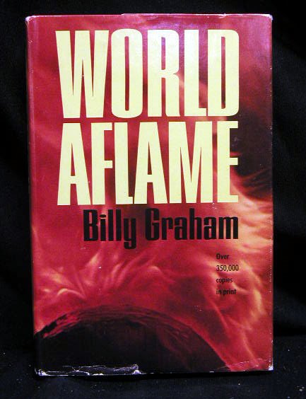 1965 Billy Graham book, signed: 1965 Billy Graham book, "World a Flame", signed. Wear on dust jacket cover.