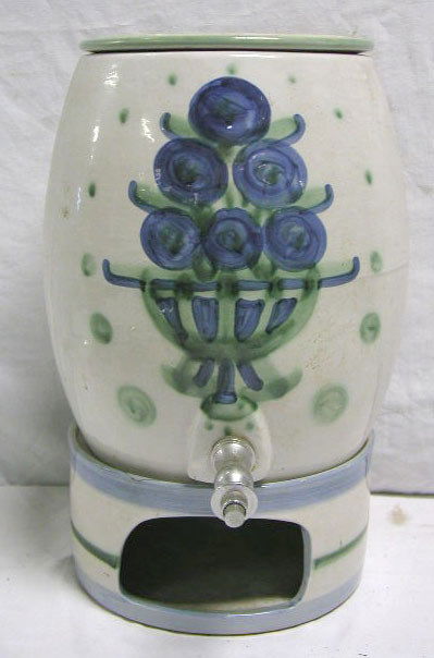 Hadley pottery water cooler: M.A. Hadley pottery 16" x 9" water cooler with painted floral design. 2" chip/crack on base (see photo). Weight < 15lbs.