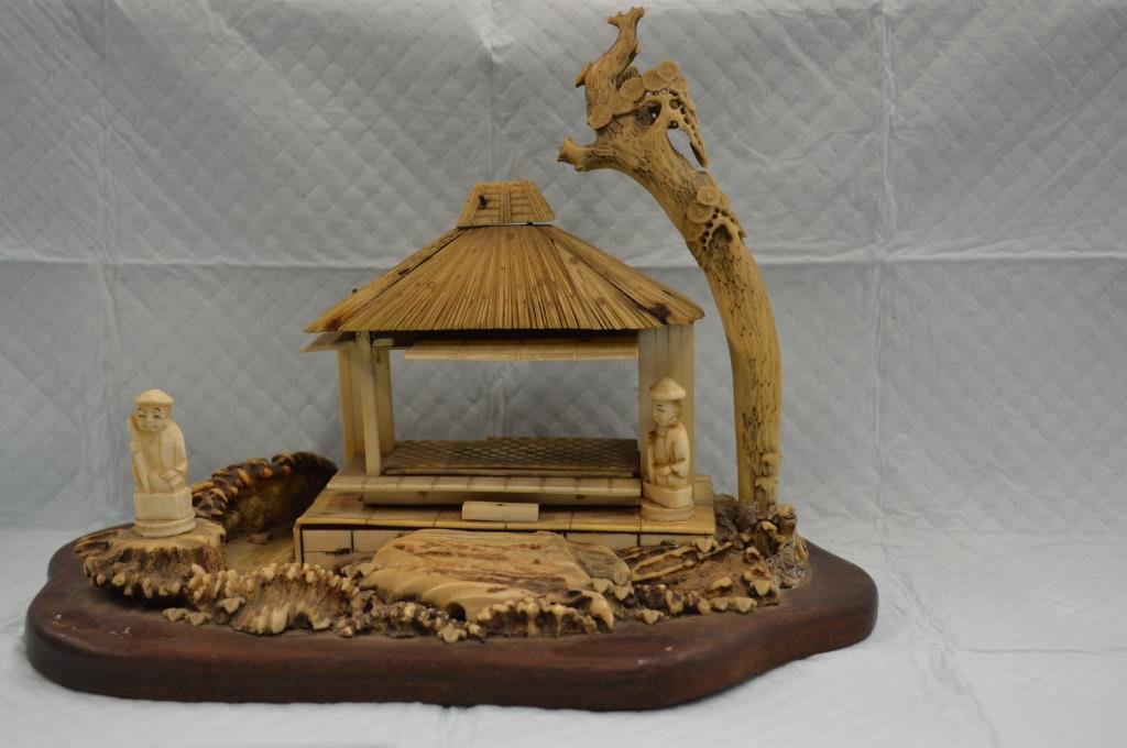 Antique Japanese Bone & Staghorn Carving: Late 19th / early 20th C. Meiji / taisho period Japanese bone & staghorn 7" (height) x 8" (length) x 5" (width) carving of figures in a garden with a pagodah. Mounted onto a 9 1/2" (length) x 5 1/4" (