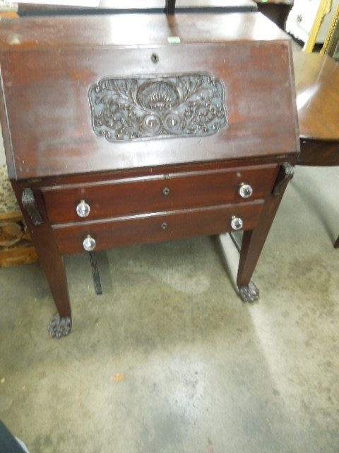 Mahogany Slope Lid Desk: Slope lid desk with shell & acanthus scroll relief carved panel & fitted interior; over 2 drawers with replaced glass pulls flanked by acanthus carved pull out slides, high tapered square legs with bo
