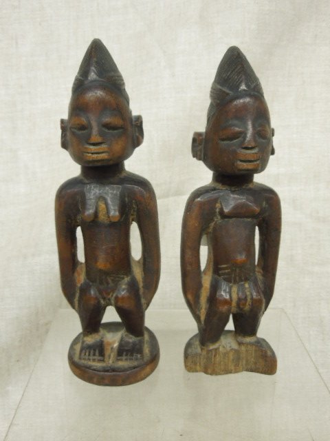 Antique African Carved Wood Figures: Pair of antique African carved wood 8 1/2" (height) x 3" (length) x 2" (width) female & male figures. CONDITION: Wood loss on base of male figure. Seperation crack from age on backside of female figur