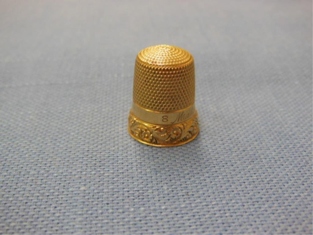 Vintage 14k YG Thimble: Vintage 14k vg thimble, size 8, engraved floral & scroll base border under a plain band inscribed "Madge Dec. 25-1901": 1.9 DWT, 3/4" hgt. CONDITION: Very good, modest wear.