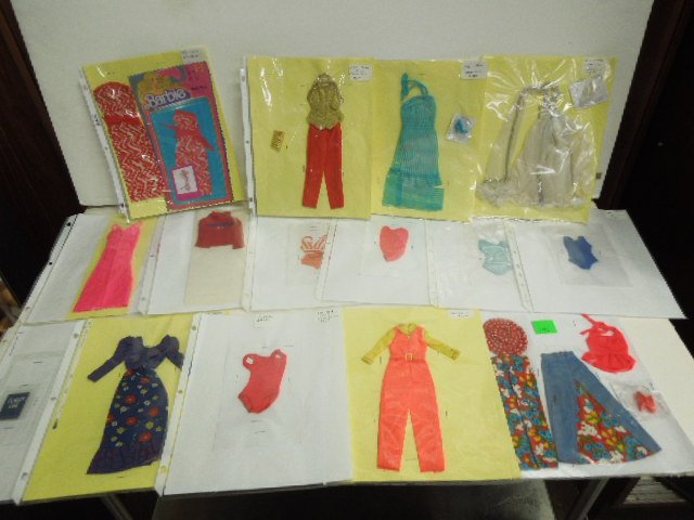 (17) 1973-1979 Barbie Outfits: Includes: 7707, 7806, 8620, (2) 8888, (2) 9720, 7210, 7809, 7807, 8587, 7796, 9836, 2210, 2778. CONDITION: Minor wear, some outfits incomplete, may have staples through some outfits.