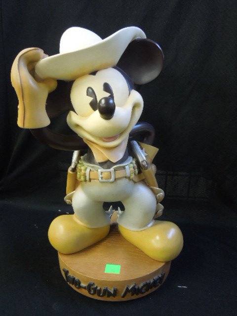 Large 2 Gun Mickey Resin Figure: Large two gun Mickey Resin figure with spurs, chaps, kerchief and hat, made in China, 19" high, with wood plank from resin base. CONDITION: Minor wear and very minor areas of paint loss (elbow and hat