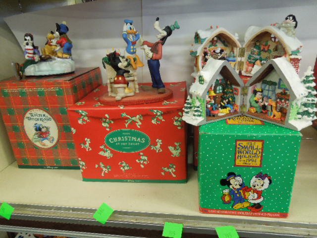 4 Resin Disney Christmas Figurines: Four resin Disney Christmas figurines including: two hinged houses with Mickey and Minnie interior scenes, 1994 It's A Small World and 1995 Christmas in our Home, plus Mickey's Winter Wonderland and 1