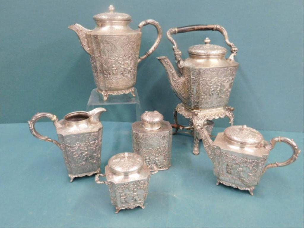 Hanau German 800 Silver Tea & Coffee Set: Circa 1874-1926 Storck & Sinscheimer makers marker Hanau German 800 silver six piece tea and coffee set decorated with relief cherub and floral designs includes: 9 1/2" (h) x 8" (l) swinging hot water