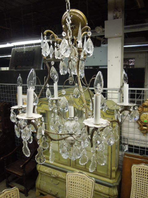Crystal & Brass Chandelier: Crystal and brass chandelier, seven light, features shaped brass frame with six arms, cut crystal drops and spears, early 20th C. 24" d, 24" h. CONDITION: Very good.
