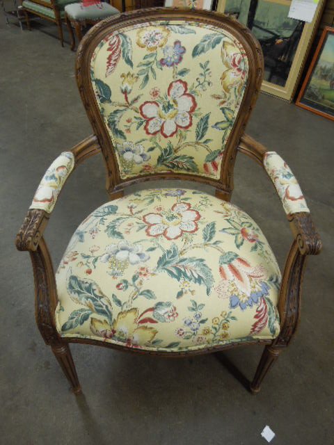 Louis XVI Style Fauteuil: Louis XVI style Fauteuil, Fruitwood, features, rope, acanthus, rosette and reed carvings, yellow floral cloth upholstery, late 20th C. 38"h. CONDITION: Modest wear.