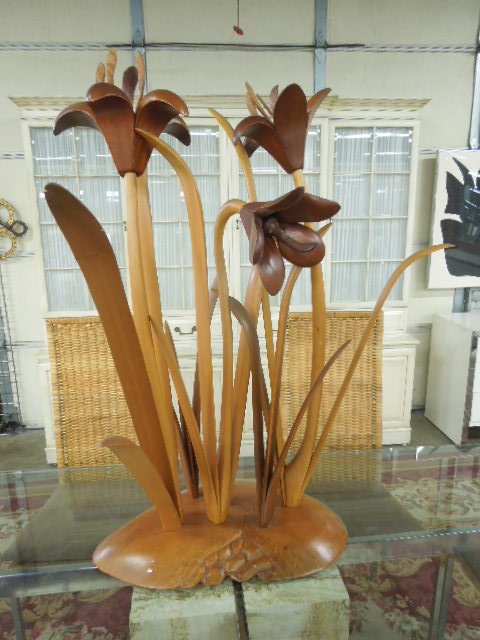 Signed Modern Mixed Wood Floral Sculpture: A. Briggs 1986 signed and dated modern era birch, mahogany and walnut mixed wood, 41 1/4" (h) x 25" (l) x 15 1/2' (w) floral sculpture. CONDITION: Center flower has petal loss. Areas with wear.