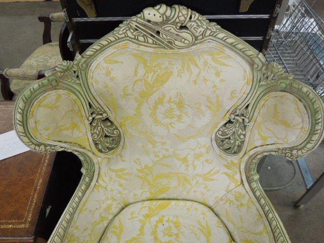 French Revival Arm Chair: French Revival arm chair, features foliate, floral and violin carvings, antique white and green highlighted finish, yellow and white floral brocade upholstery, mid 20th C., height 44". CONDITION: Mino
