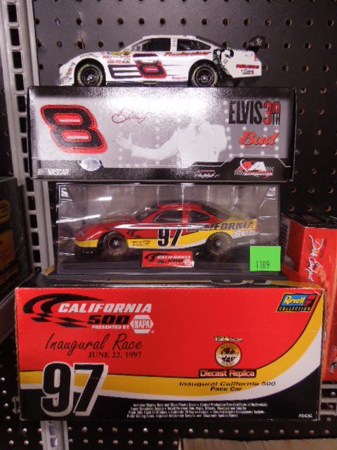 3 Diecast Stock Cars: Three diecast stock cars. Includes: Dale Earnhardt Jr. by Motosport Authentics - no COA, 1997 California 500 pace car with COA by Revell, and 1:32 scale. Dale Jr. Bud car by Action. CONDITION: Very go