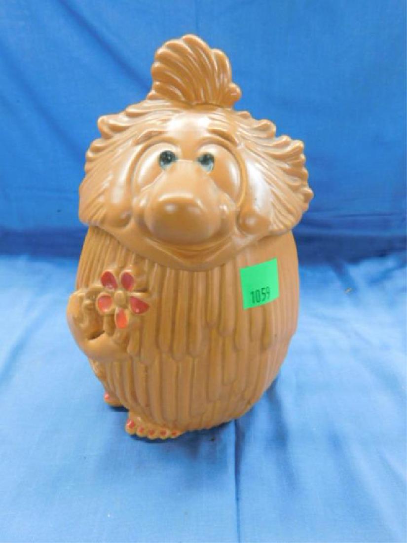Haeger Ceramic Cookie Jar: Haeger ceramic cookie jar, 1970s style shaggy hair man with flower Haeger mark on bottom, 11 1/2". CONDITION: Two minor rim chips on jar (covered by head lid.