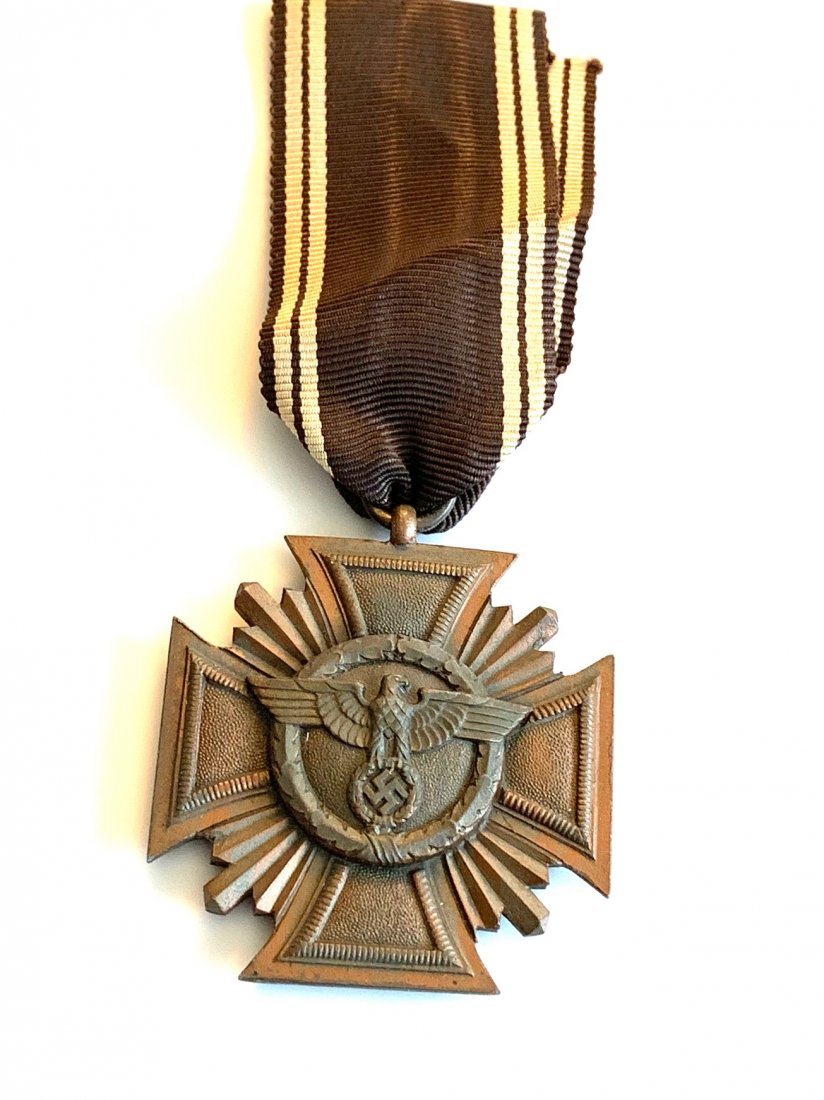 A NSDAP 10 YEAR LONG SERVICE AWARD 3RD CLASS HEAVY: Front features national eagle encompassed by an oak leaf wreath on a bown/bronze field. Reverse has Gothic script "Treue fur Fuhrer und Volk" (Loyalty to Leader and People) on a brown/bronze field als