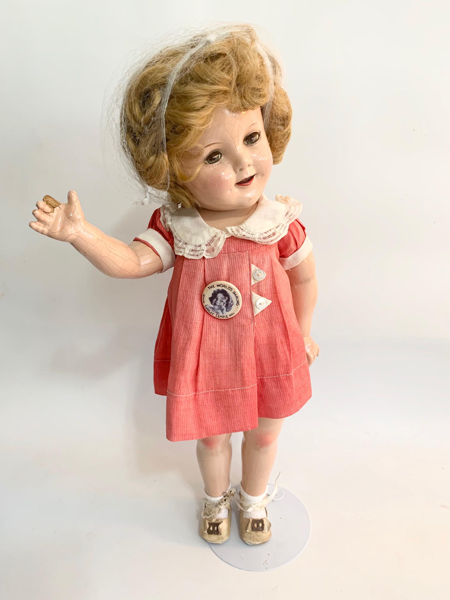 Shirley Temple Doll Ideal 17" Composition: Ideal Shirley Temple 17" Composition Doll; Poor condition big crack on neck; mouth repainted; origina faded Red Triangle dress with NRA tag; original underwear and original wig. We do our best to list