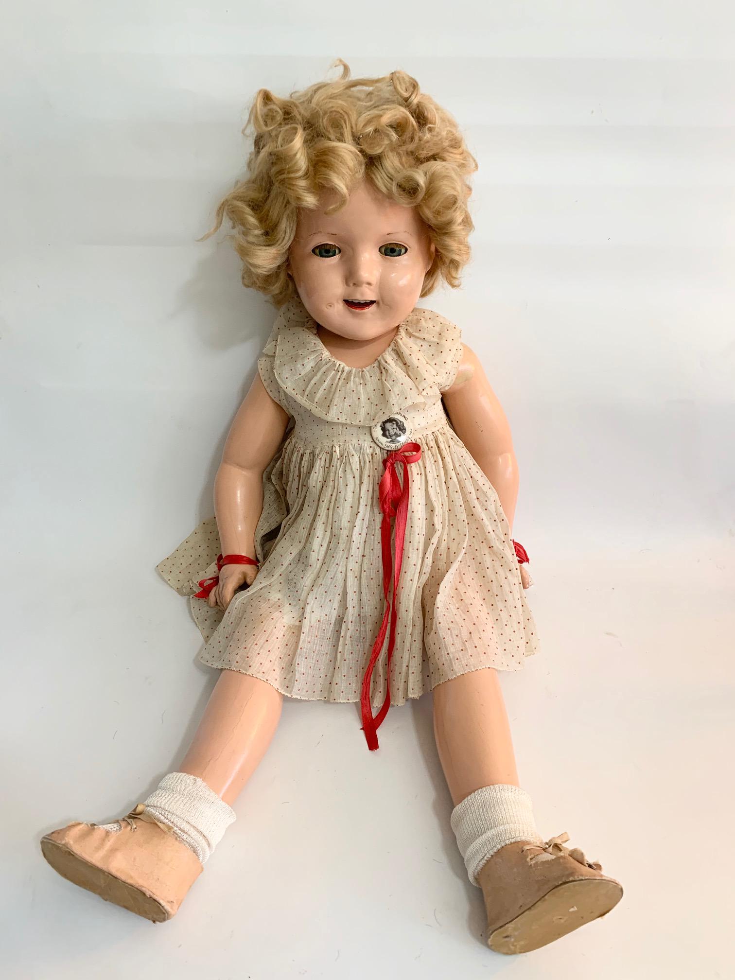 B3: Shirley Temple 27" Composition Doll: Shirley Temple Doll; 27" Composition with flirty eyes in good condition; Original red/white swiss dot; orginal underwear; correct shoes with original wig. We do our best to list all possible flaws, th