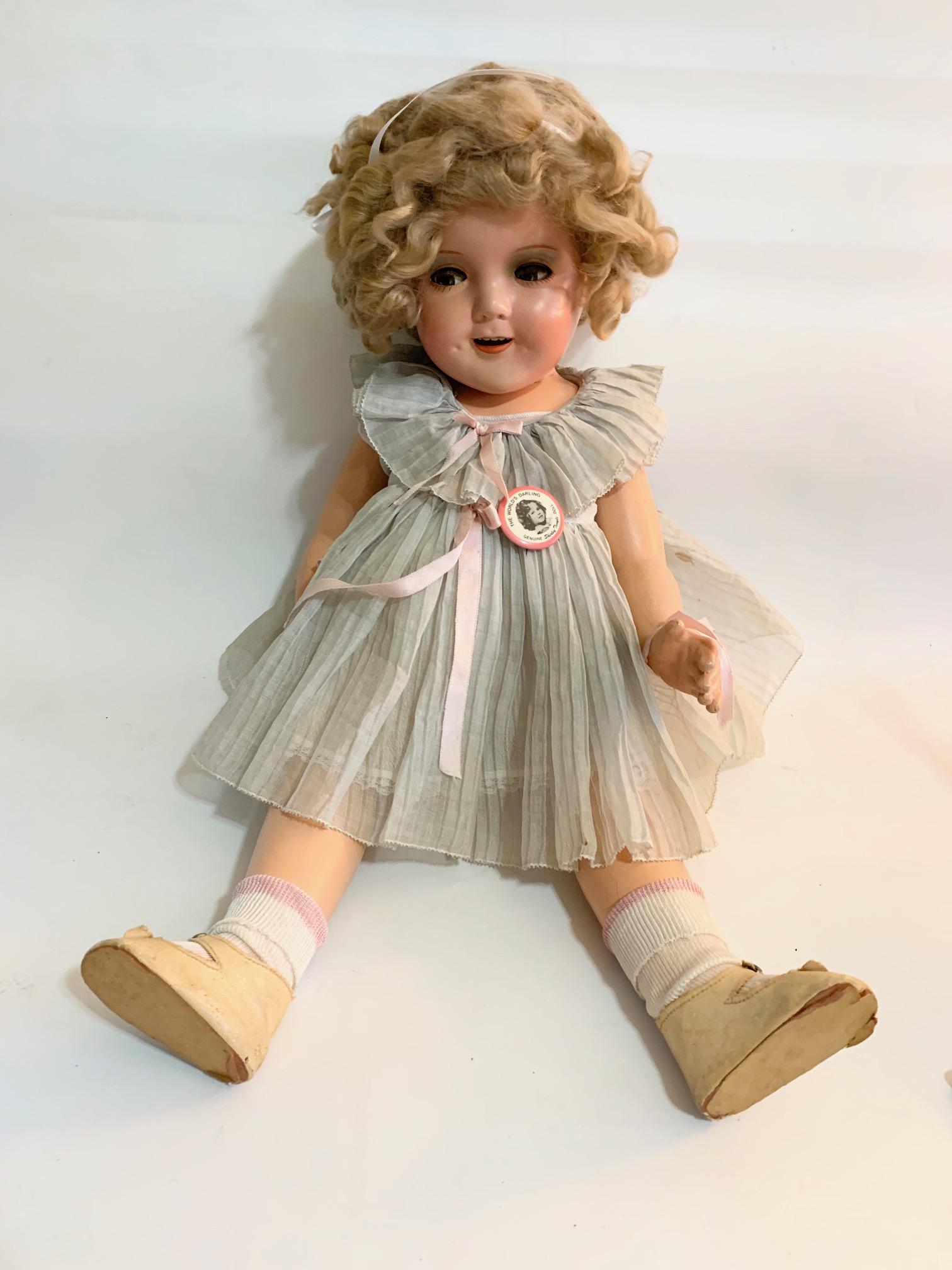 B6: Ideal Shirley Temple 25" Composition Doll: Ideal Shirley Temple 25" Composition Doll with flirty eyes; they get stuck a bit; Head painted restored, original tagged dress with a few stans; flocking on dress inact; shoes original in poor conditi