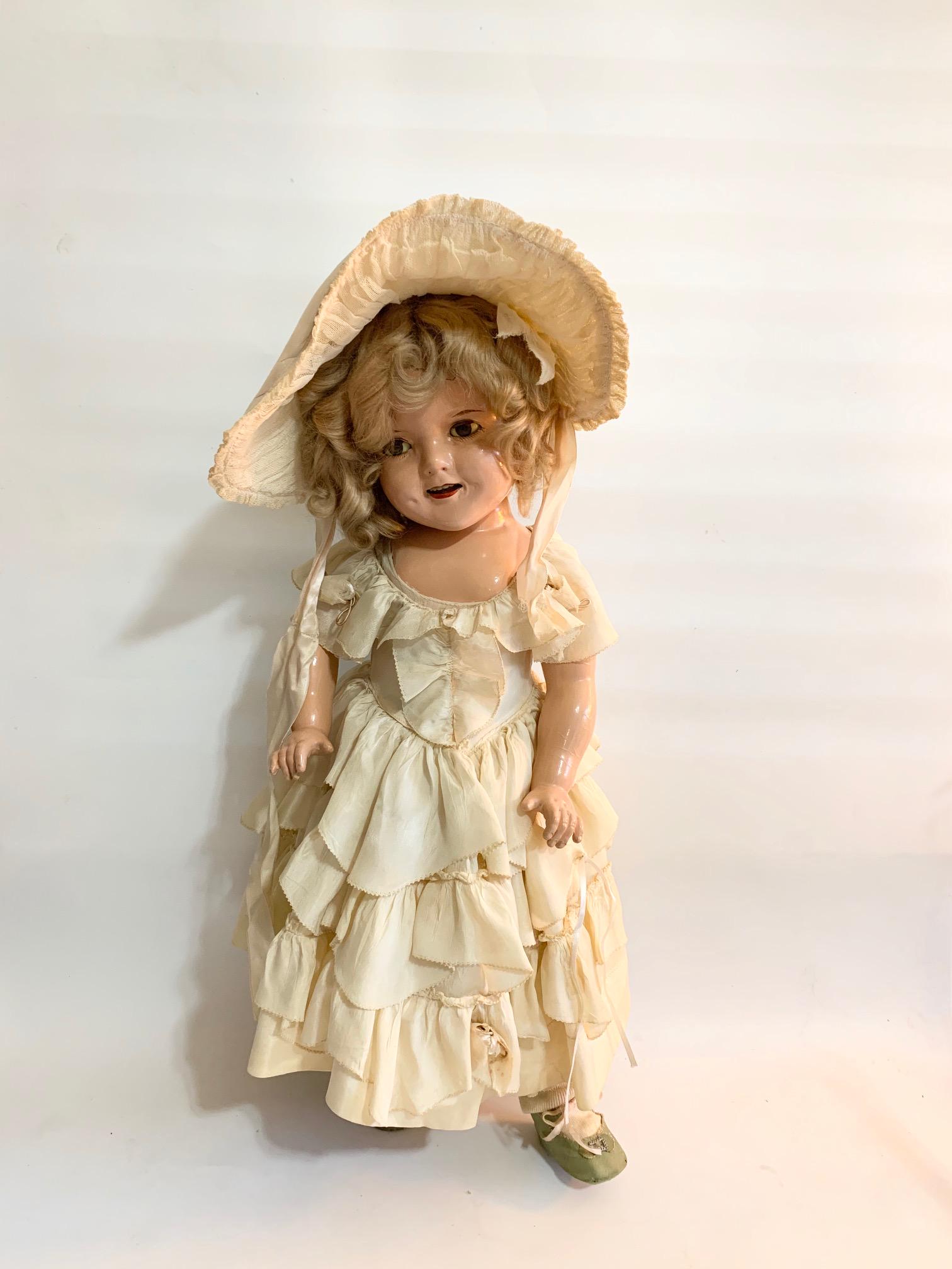 B6: Ideal Shirley Temple Little Colonel 21" Composition: Ideal Shirley Temple 25" Composition Doll wearing original Little Colonel Dress; original hat with beautiful pantaloons; correct shoes and original wig; Possible that eyebrows and mouth repainted. We