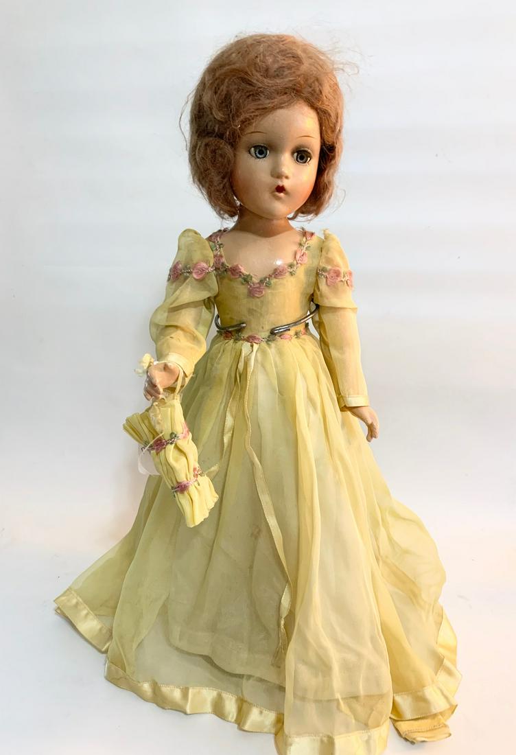 B7: Madame Alexander 17" Composition Bridesmaid: Madame Alexander 17" Composition Bridesmaid; face and body crazing; original tagged yellow organza dress with matching muff; original underwear; relaced stockings; relaced shoes but old. We do our bes