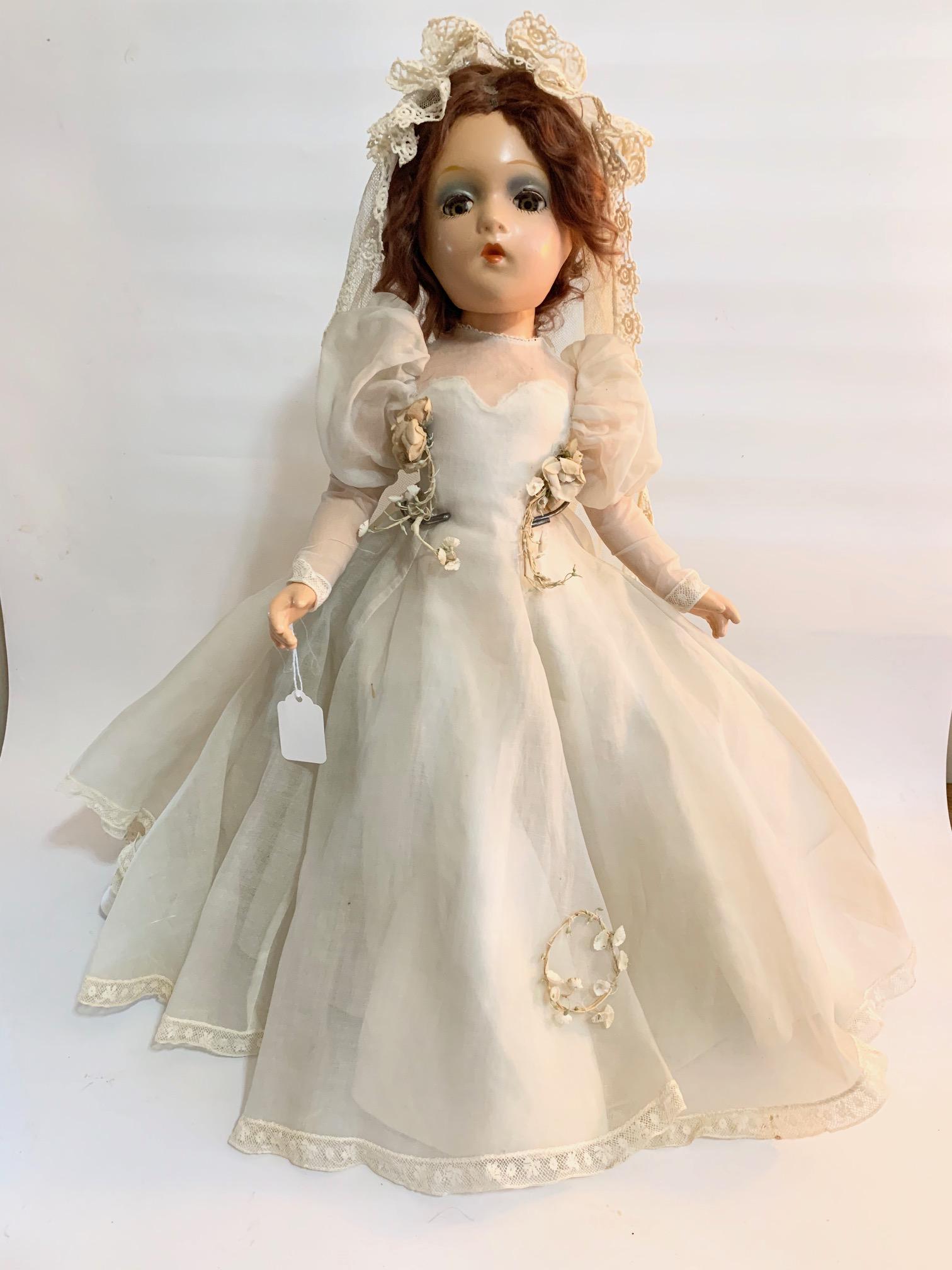 B7: Madame Alexander Portrait Bride Sally 20": Madame Alexander Portrait Sally Bride 20" Composition Doll; original tagged organdy gored dress with veil; very tin holes in veil; original flowers on dress and waist; original auburn mohair. We do ou