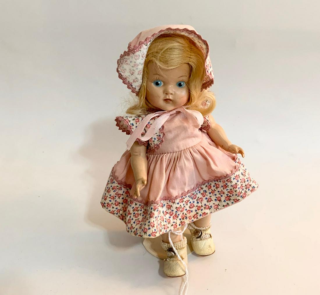 B15: Girl Doll Vogue 1940's Toddles 8" Doll: Girl Doll Vogue 1940's 8" doll; painted eyes; newer vogue dress with tag and original shoes; original wig. We do our best to list all possible flaws, these are vintage/antique dolls and are NOT perfec