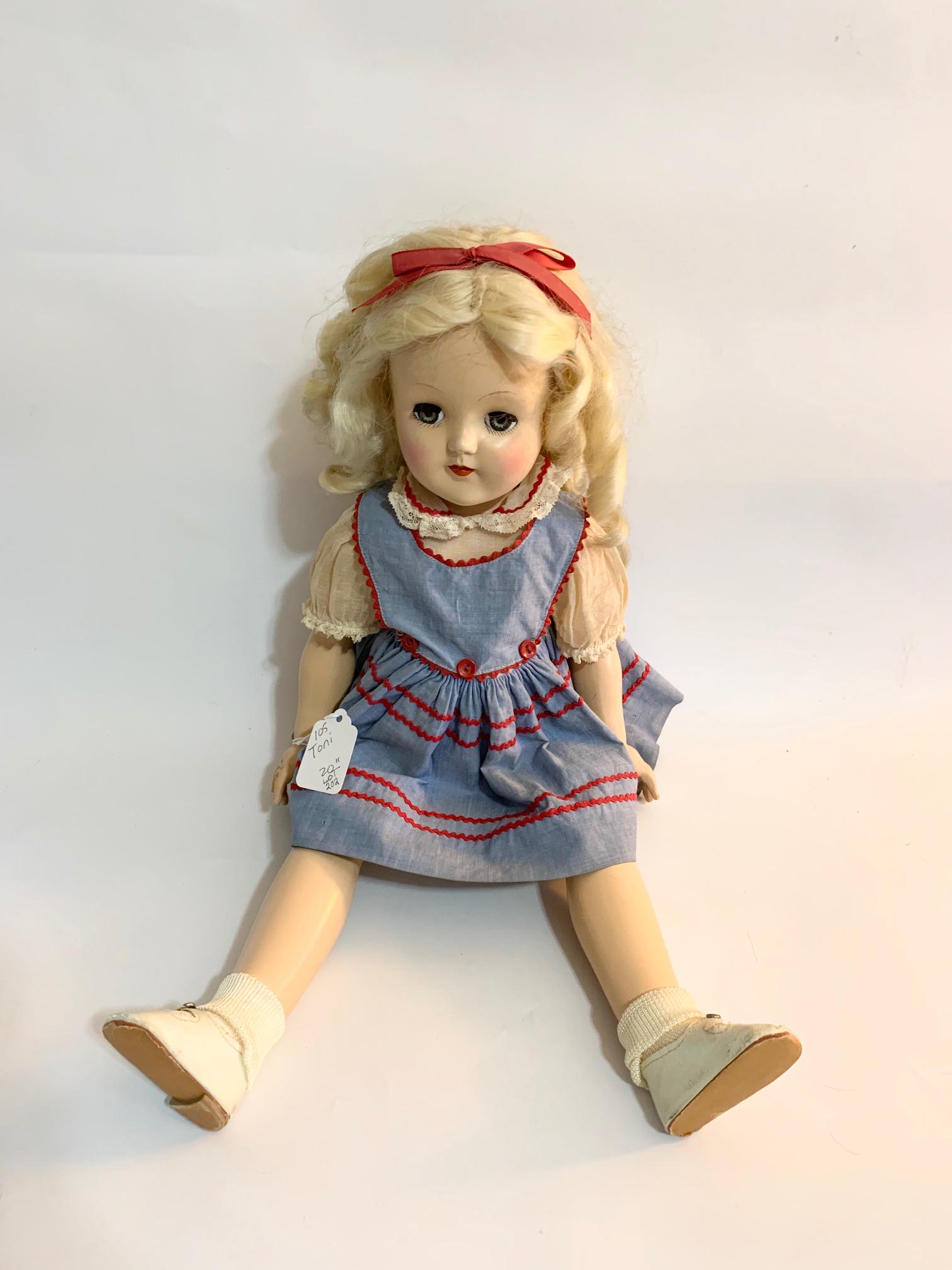 B17: Ideal Toni P93 21" Hard Plastic Doll: Ideal Toni P93 21" Hard Plastic Doll; all original blue pinafore dress with red trim and white organdy blouse; shoes may be original ; original curly long blond wig. We do our best to list all possibl