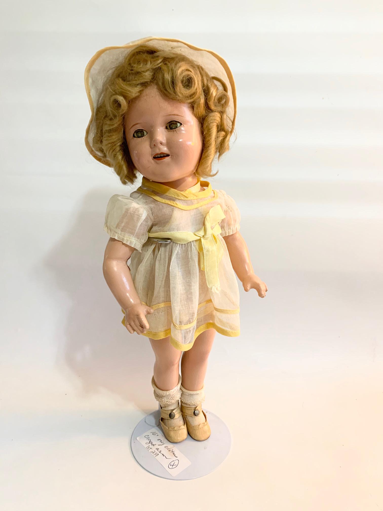 B-19: Shirley Temple 16" Composition Doll: Shirley Temple 16" Composition Doll; crazing on one arm; eyes blown; all original clothing and original wig. We do our best to list all possible flaws, these are vintage/antique dolls and are NOT perf