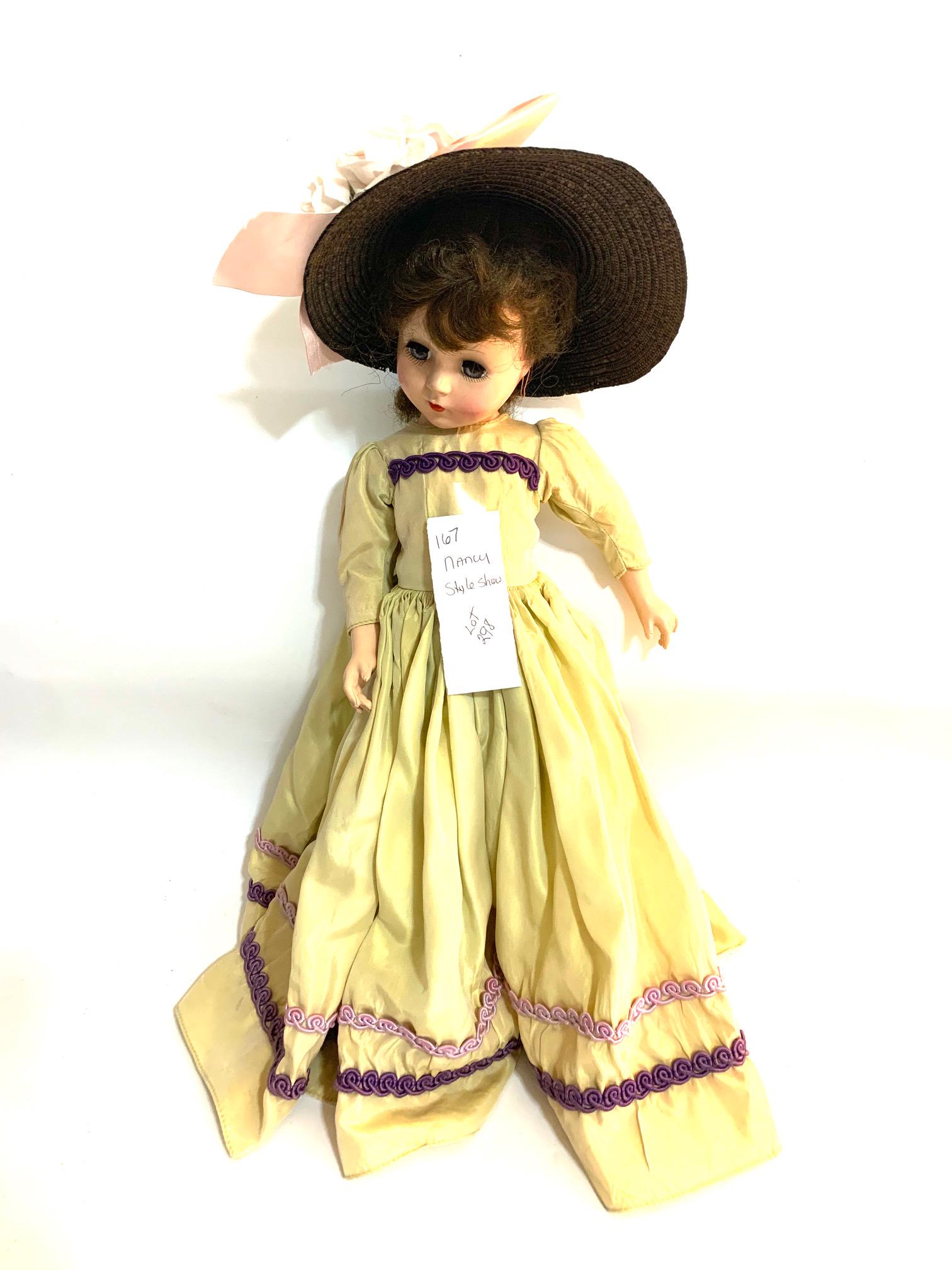 B22: Nancy Ann Story Book Breath of Spring Style Show: Nancy Ann Story Book Breath of Spring Style Show 18" Hard Plastic Doll; original dress; black straw hat with flowers. We do our best to list all possible flaws, these are vintage/antique dolls and are