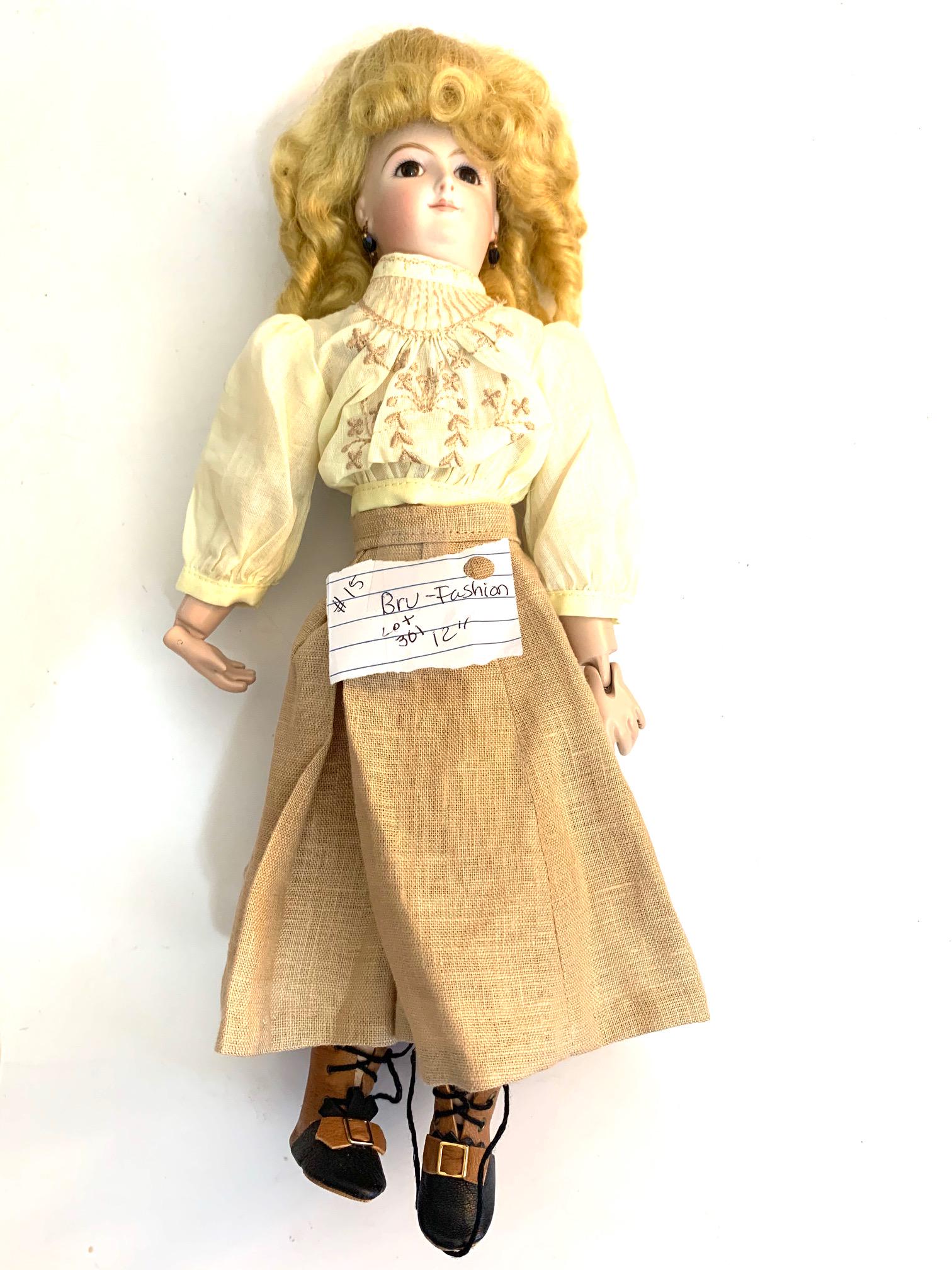 B23: Smiling Bru 12" Bisque Head: Smiling Bru 12" bisque head; seeley body; yellow blouse and brown skirt; blonde wig. We do our best to list all possible flaws, these are vintage/antique dolls and are NOT perfect. Please refer to the