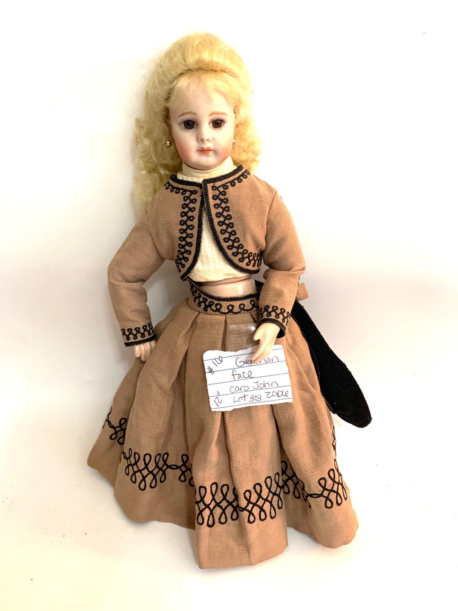 B23: 12" Reproduction Girl Caro Jon 2006: Reproduction German Girl Doll-sign Caro Jon 2006; 12" Bisque Head; brown dress and jacket with Black trim; no underwear; no shoes; original blonde wig. We do our best to list all possible flaws, these