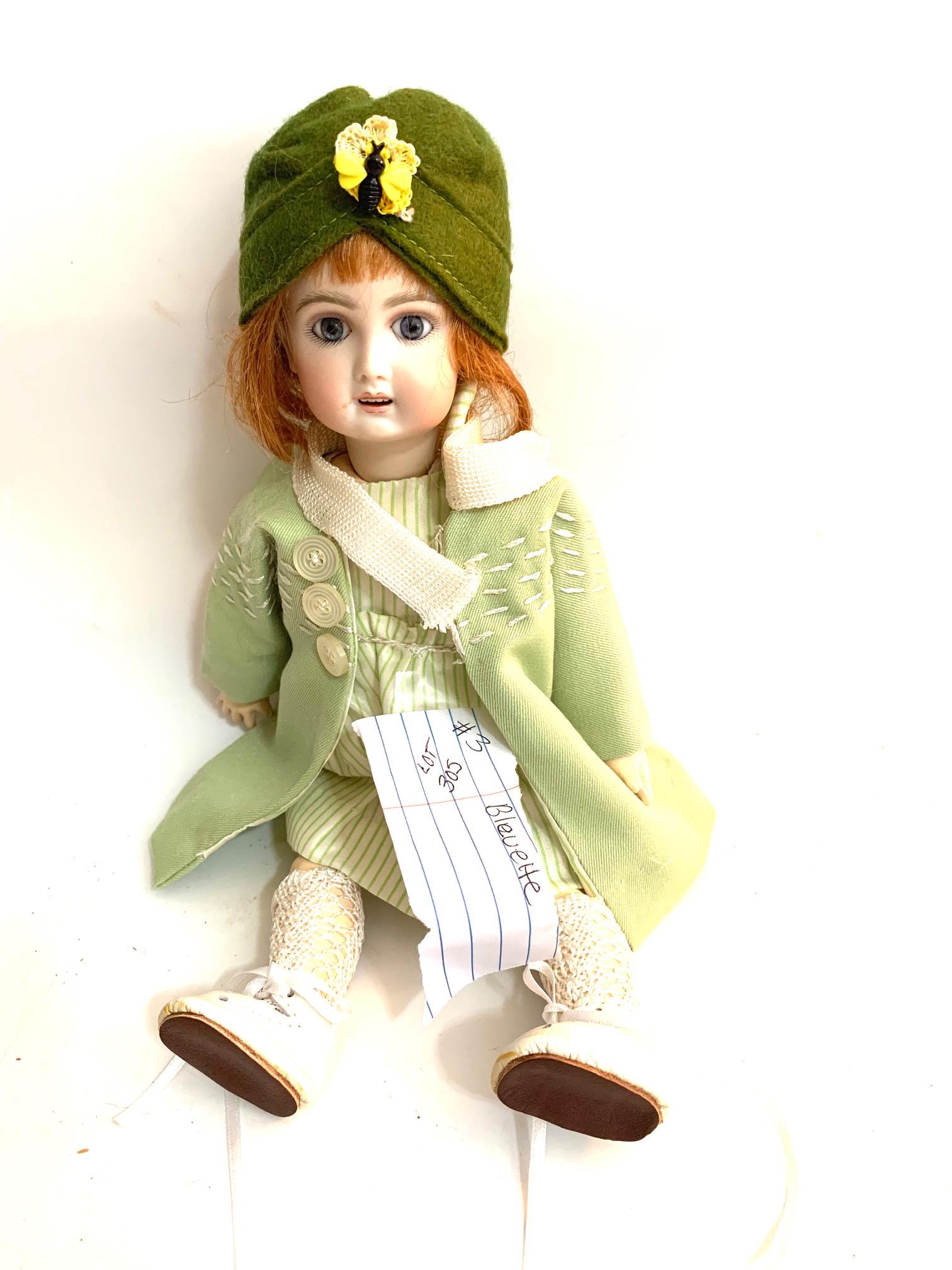 B23: Reproduction Bleuette Size 10 Unsigned 2012: Reproduction Bleuette Size 10; unsigned 2012 11" Bisque Head; green striped dress; original green coast with line embroidery; original green hat; auburn wig. We do our best to list all possible flaws,