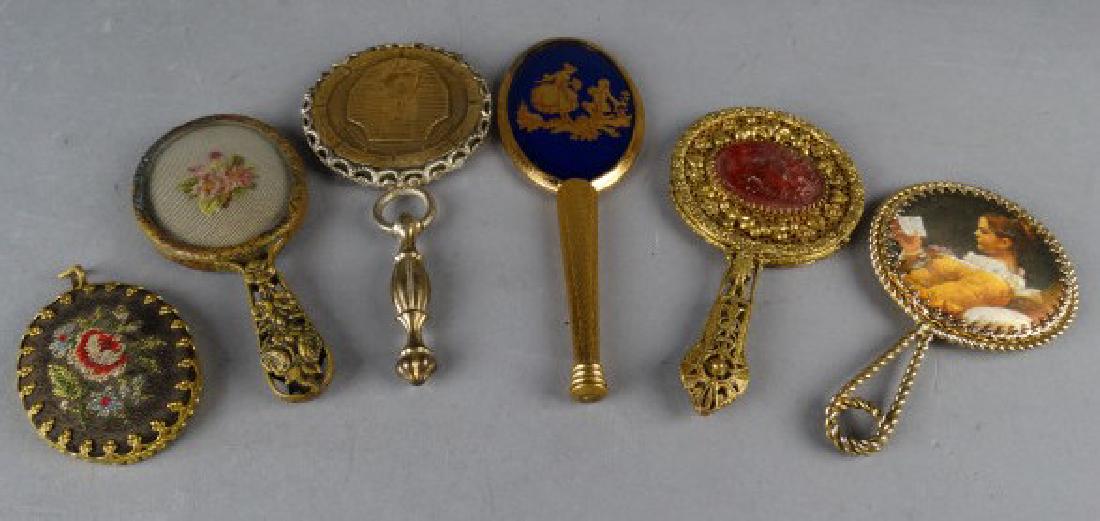 Lot of 6 Gold Tone Hand Mirrors: Lot of 6 Gold Tone Hand Mirrors two with needlepoint work and one enamel.