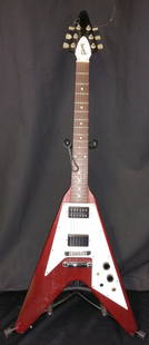 GIBSON CUSTOM SHOP ‘67 FLYING V REISSUE: Manufactured in 2006 by Gibson Custom Shop. The Flying V was originally introduced in 1958, the produced again in 1967. The finish is Heritage Cherry. There has been modifications on the guitar, one o