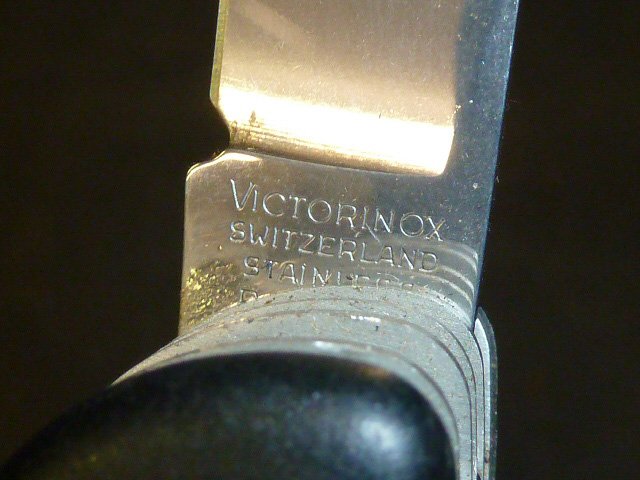 VICTORINOX | SWITZERLAND | 11 IMPLEMENTS: Real deal Swiss Army Knife. Black handle. 11 implements. Largest blade is approximately 5 1/2 inches. Large Pocket Knife with Metal SawRobust, rugged and ready for anything, the Work Champ is the ulti