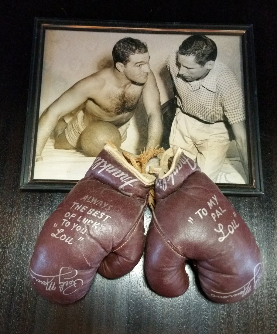 Rocky Marciano Signed Gloves and Photo: Franklin Miniature Boxing Glove Set signed and inscribed by boxing legend Rocky Marciano to his friend Lou Goldstein. 8 by 10 inch original black and white photo of Marciano and Goldstein taken while
