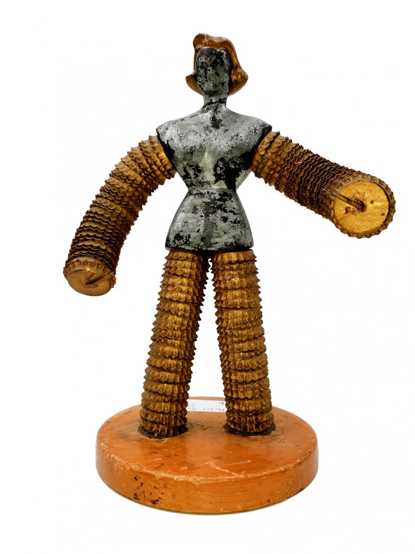 Metal Female Form, Bottle Cap Limbs, Art: Mixed Media - Metal Female Form on wood base. Metal Grey Body. Head and torso from cast metal, stacked bottle caps over heavy gauge wire for limbs. Presented on a wood base. Details created with accen