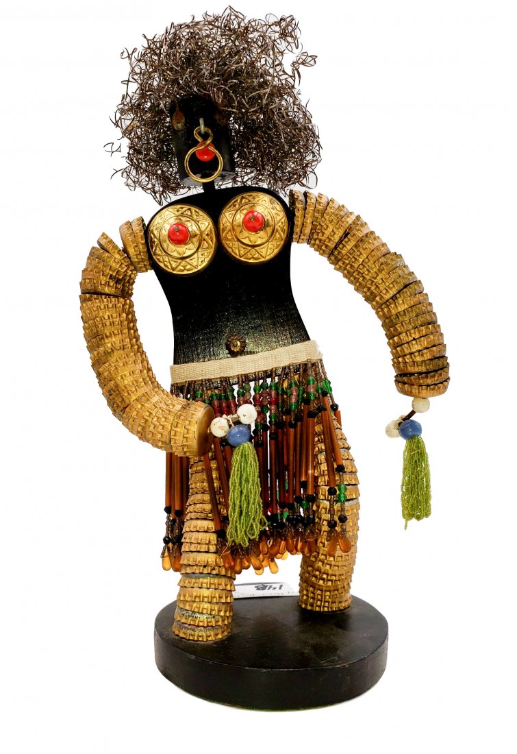 Mixed Media Female Form Beaded Bottle Caps: Mixed Media - Female Form on wood base. Beaded details. Head and torso from wood, stacked bottle caps over heavy gauge wire for limbs. Presented on a wood base. Details created with accent paint, bead