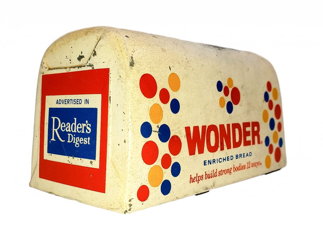 Vintage Metal Wonder Bread Bank: Vintage Metal Wonder Bread Bank. Vintage pot metal bank in the form of a bread loaf. Age and moderate wear noted to paint graphics, missing bottom plug. Size: 3 inches high on 3 x 6 inch base.
