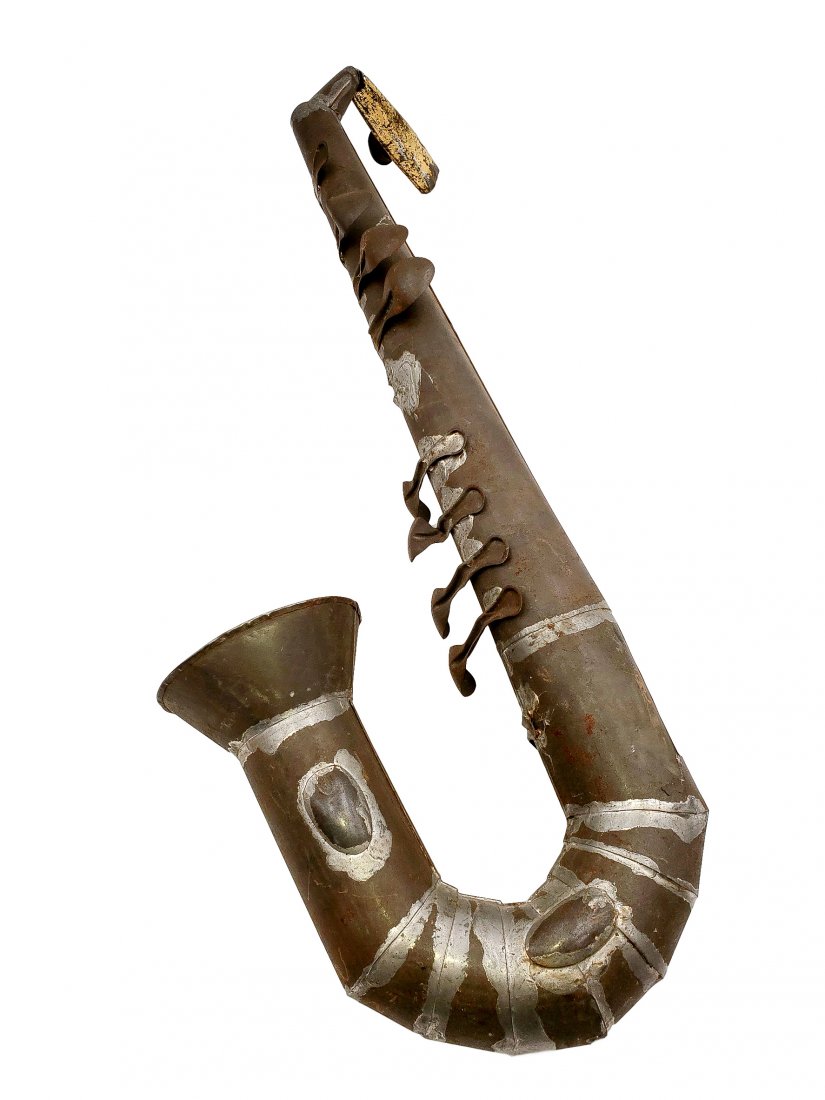 Tin Saxophone Wall Art: Tin Art Saxophone Wall Art. Sheet metal, found objects, spoons, and a kazoo formed to a sculptural saxophone. Size: 23 inches long