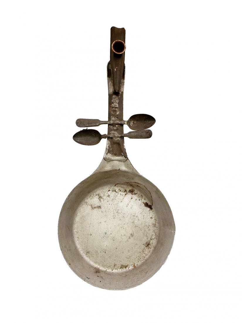 Metal Art Instrument - Sculptural Banjo Wall Art: Tin Art Instrument - Sculptural Banjo. Frying pan, found objects, spoons, and a kazoo formed to a sculptural instrument resembling a banjo. Size: 18.5 inches.