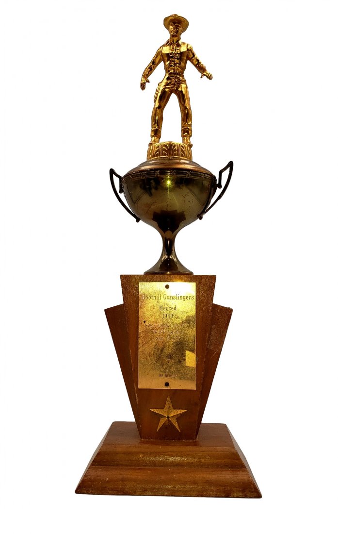 1959 Boothill Gunslingers Merced 1959 Trophy: Boothill Gunslingers Merced 1959 Trophy. Fast Draw Contest 2nd place Professional Award. Gunslinger figure atop a loving cup of gold wash over metal on a geometric wood plinth. No condition issues not