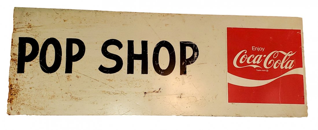 Coca-Cola Pop Shop Metal Sign: Metal sign with Coca-Cola decal and painted Pop Shop. The sign has light rust, some paint loss, scratches. 46 inches by 16 inches tall and 1 inch deep.