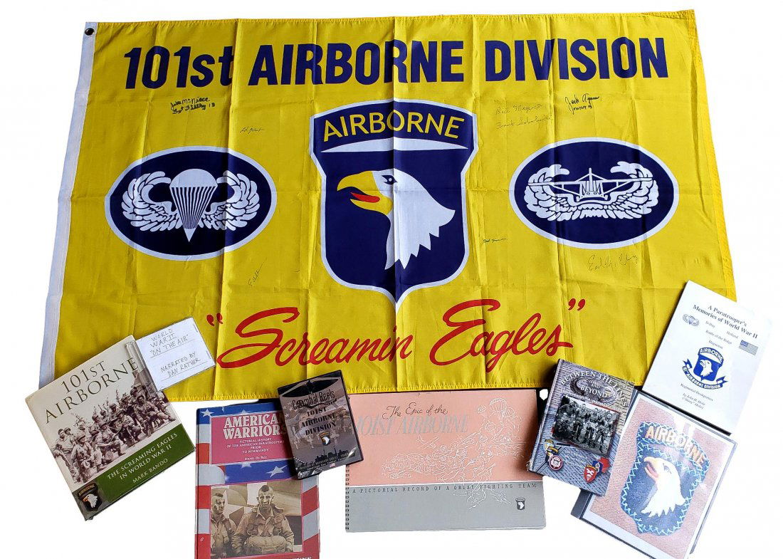 101st Airborne WWII Paratroopers Autographed Lot: A) 37 x 60-inch Screaming Eagles Flag Autographed by 101st Airborne Division, Easy Company 506, known as the "Band of Brothers" that invaded Normandy: Jake McNiece *Bastogne Pathfinder*; Ed Joint; Bil