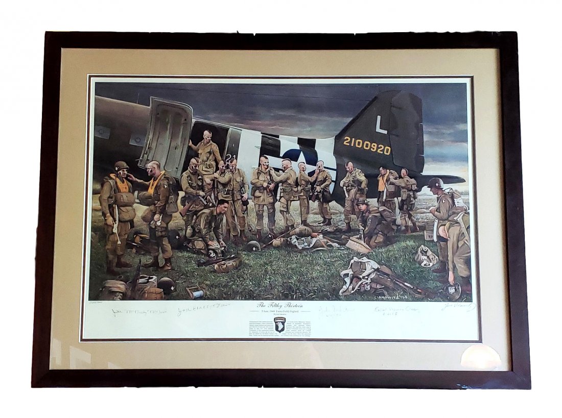 The Filthy 13 - by Joel Iskowitz Signer Proof Framed: "This print depicts the D-Day preparation of the Filthy Thirteen after they have painted their faces, shaved Mohawks on their heads, and dawned their gear to load their C47. A photographer immortalize