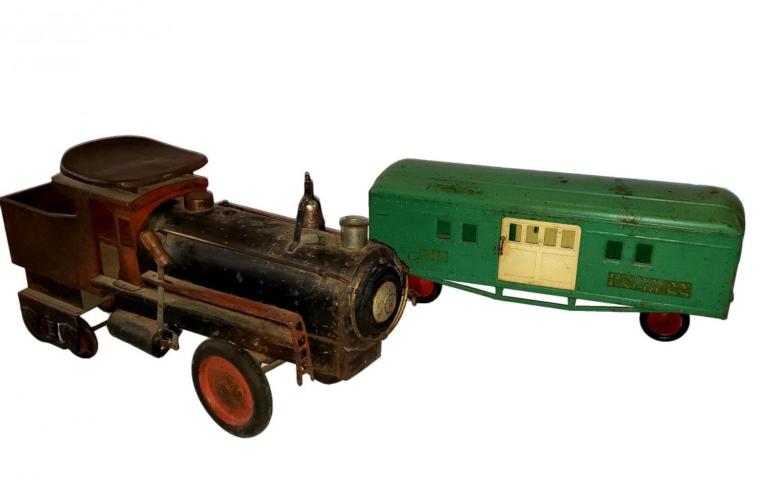Railway Express - Antique Toddler Ride On: Pressed metal ride on locomotive and tow behind - passenger car- toddler size ride on. Engine car is black and red with some original paint remaining, rubber tred front wheel and metal back wheels as 