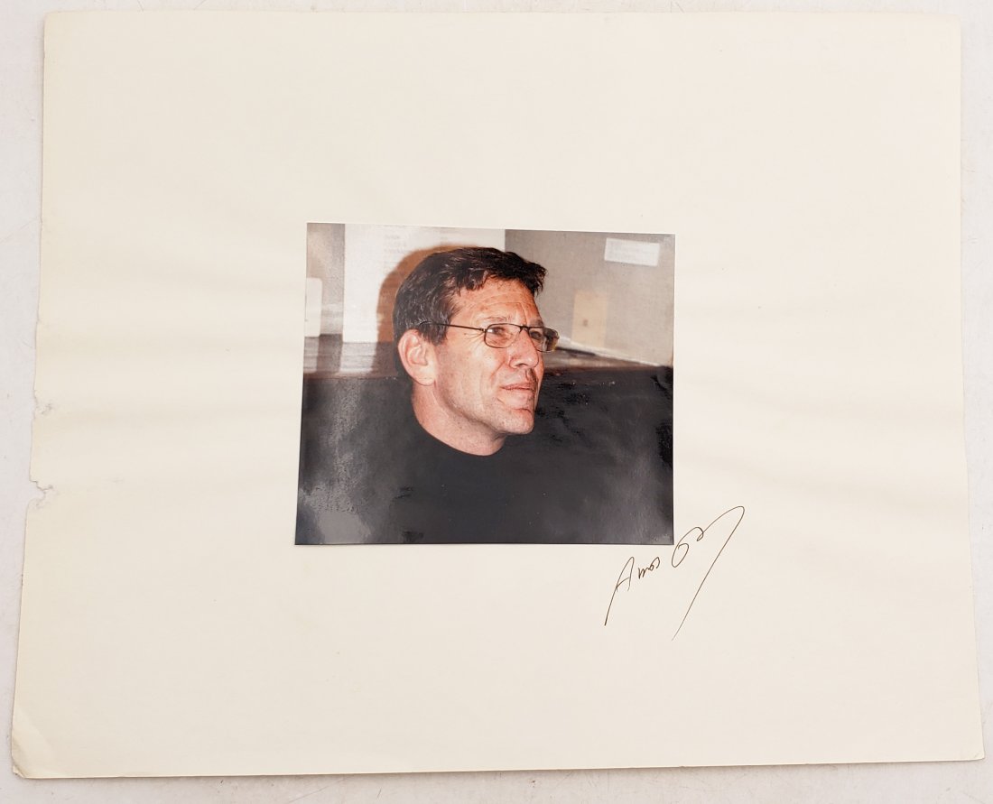 Amos Oz: Signed Photo Portrait: Color photo of Amos Oz from the collection of P.Rankin- Smith mounted on art paper /board and signed on the margin by Amos Oz. The signature is authentic with provenance. Image size : 4.5 x 5.5 inches