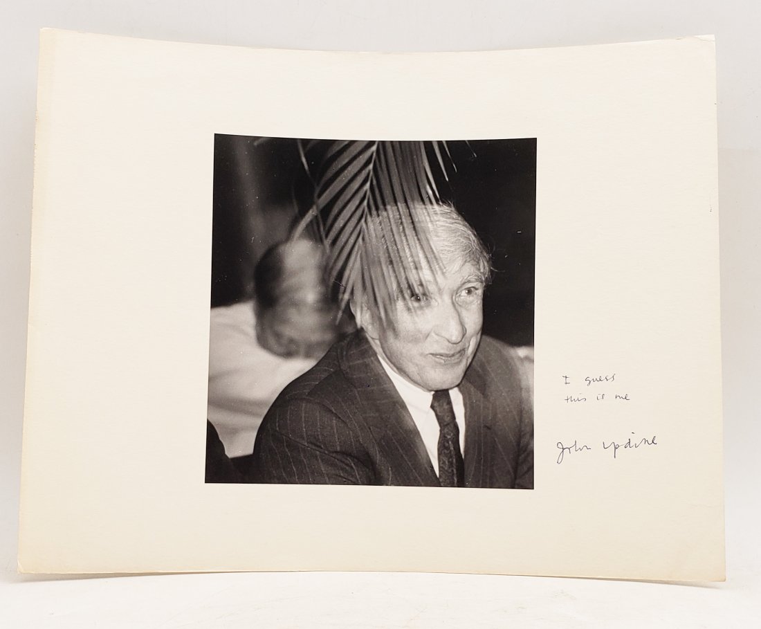 John Updike, 1989: Signed Photo Portrait: B/W photo of John Updike, 1989 by P.Rankin- Smith mounted on art paper /board and signed on the margin by John Updike. The signature is authentic with provenance. Image size : 6.75 x 7.25 inches. Moun
