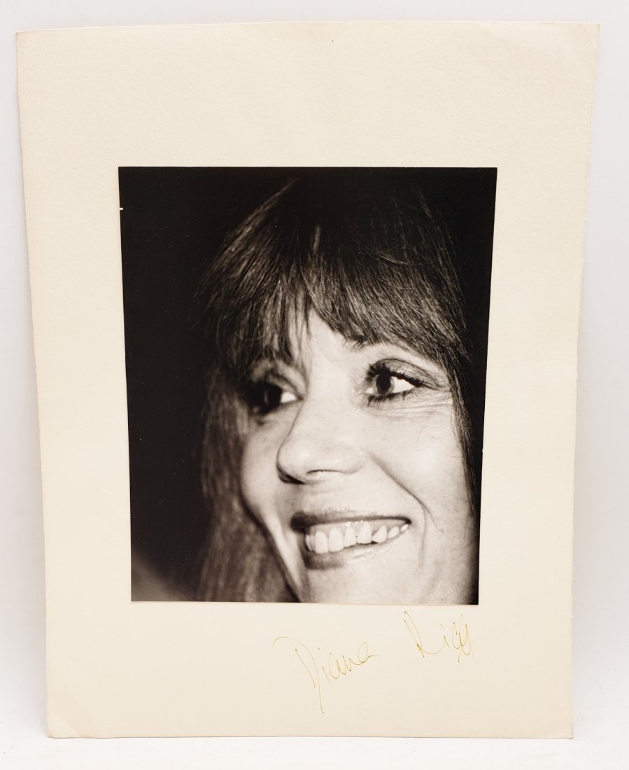Diana Rigg: Signed Photo Portrait: B/W photo of Diana Rigg by P.Rankin- Smith mounted on art paper /board and signed on the margin by Diana Rigg. The signature is authentic with provenance. Image size : 7.25 x 8.5 inches. Mount size: 1