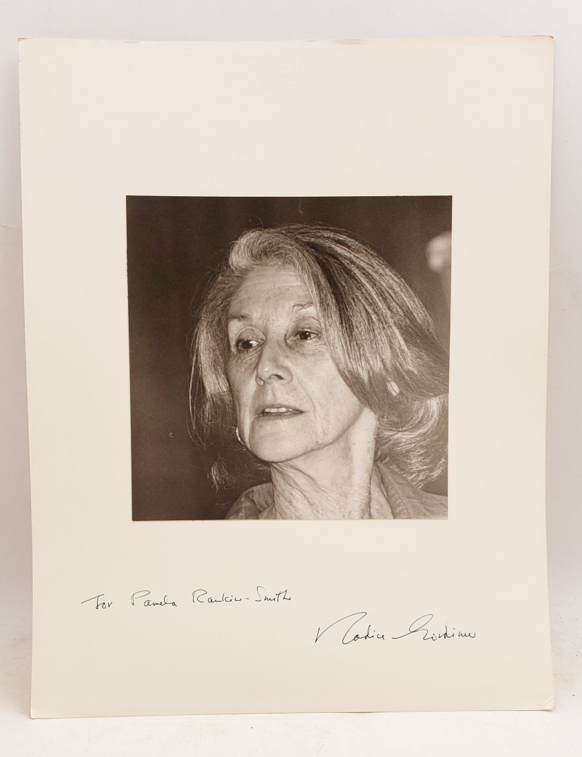 Nadine Gordimer, 1990 : Signed Photo Portrait: B/W photo of Nadine Gordimer by P.Rankin- Smith mounted on art paper /board and signed on the margin by Nadine Gordimer. The signature is authentic with provenance. Image size : 7 x 7 inches. Mount si