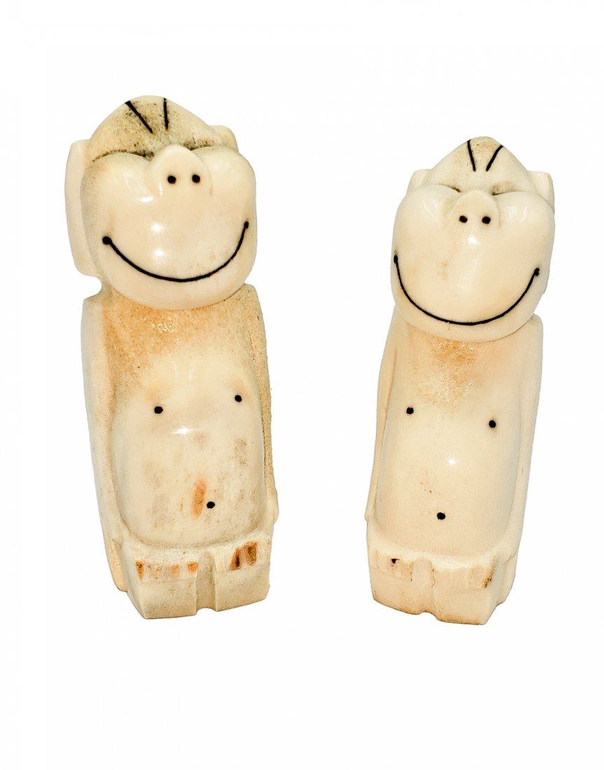Carved Bone : Happy Monkeys: A well-paired set of two happy, smiling monkey characters, carved from polished bone. 3.25 and 3.5 inches high. BOne is a natural product and will have some variations in color and texture as a result