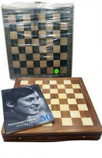 Luxury Karpov Signed Chess Set Lot: Boxwood and Walnut: Luxury wood board of boxwood and walnut designed by Seven-time World Chess Champion Anatoly Karpov. The design includes weighted carved wood pieces with rounded bases that glide smoothly over a beauti